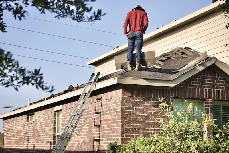 Professional roofer working on a residential roof in Island Park